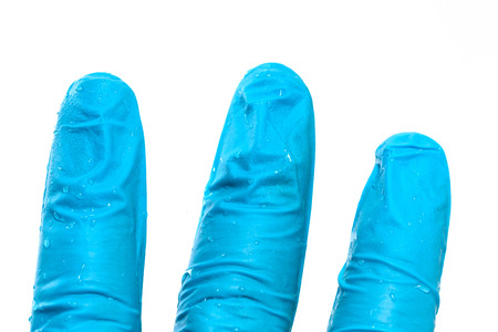 close up of hand in blue glove with water