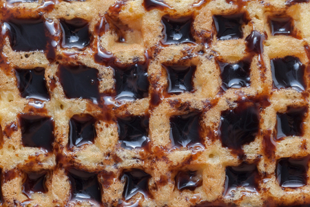 abstract texture of waffle with melted chocolateの写真素材