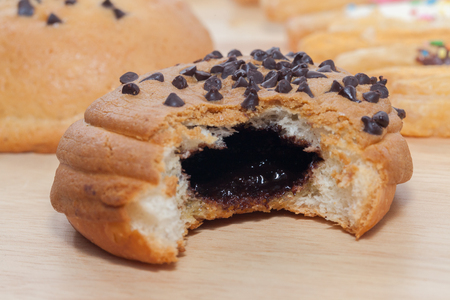 Chocolate Chips Coffee Bun on wooden plateの写真素材