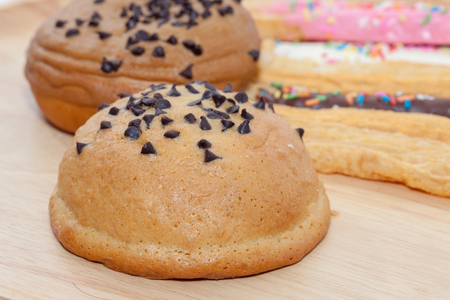 Chocolate Chips Coffee Bun on wooden plateの写真素材