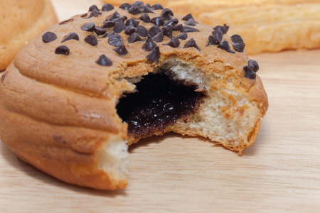Chocolate Chips Coffee Bun on wooden plateの写真素材
