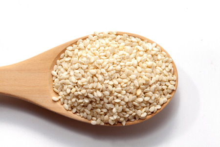 white Sesame on wood spoon on white backgroundの写真素材