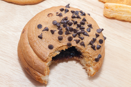 Chocolate Chips Coffee Bun on wooden plateの写真素材