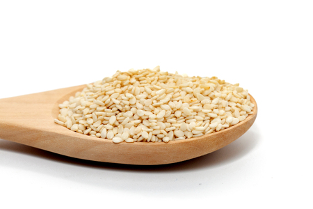 white Sesame on wood spoon on white backgroundの写真素材