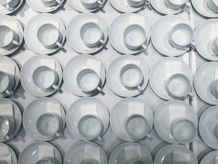 empty row of coffee cup on the tableの写真素材