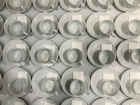 empty row of coffee cup on the tableの写真素材