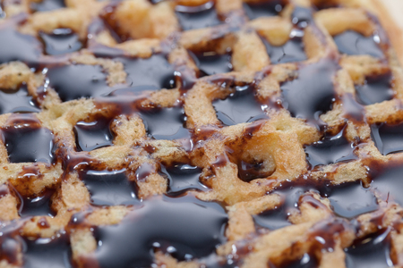 Waffles with melted chocolate on wooden plateの写真素材