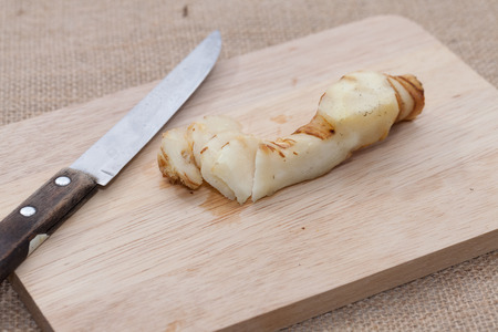 close up of Galangal on wooden cutting boardの写真素材