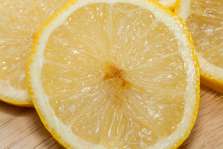 lemon on cutting board on white backgroundの写真素材