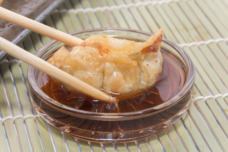 fried pork gyoza dumplings with chopstickの写真素材