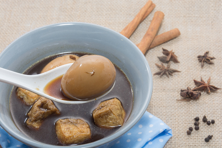 Eggs boiled stewed in the gravy on white backgroundの写真素材
