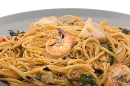 spaghetti with seafood on plate isolated on white backgroundの写真素材