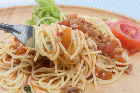 close up of spaghetti with sauce and forkの写真素材