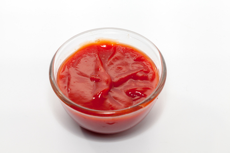tomato sauce in bowl on white backgroundの写真素材