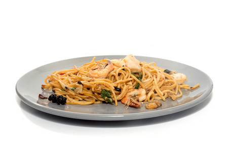spaghetti with seafood on plate isolated on white backgroundの写真素材