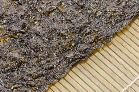 close up of seaweed sheet on white backgroundの写真素材