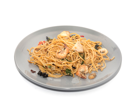 spaghetti with seafood on plate isolated on white backgroundの写真素材