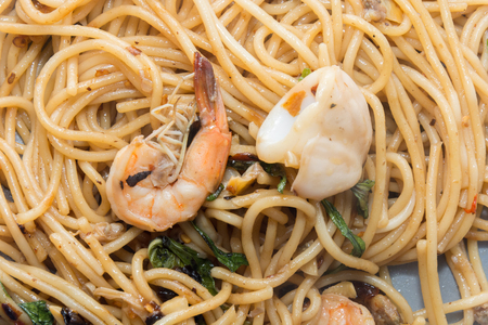 spaghetti with seafood on plate isolated on white backgroundの写真素材