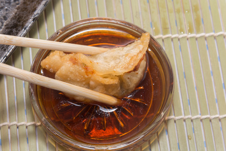 fried pork gyoza dumplings with chopstickの写真素材