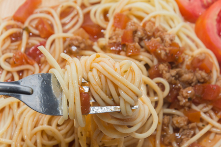 close up of spaghetti with sauce and forkの写真素材
