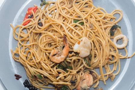 spaghetti with seafood on plate isolated on white backgroundの写真素材