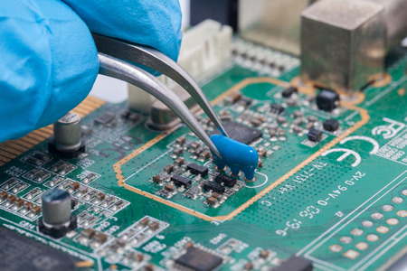 blue glove and Print Circuit Board of graphic cardの写真素材