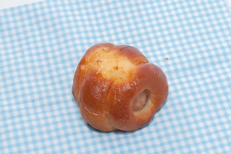 close up of chicken sausage bun on fabricの写真素材