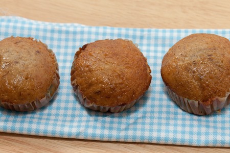 row of banana cupcake on wooden plateの写真素材
