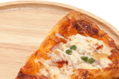 a piece of pizza on wooden plateの写真素材