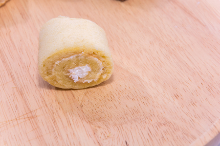 close up of roll cake on wooden plateの写真素材