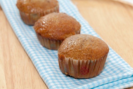 row of banana cupcake on wooden plateの写真素材
