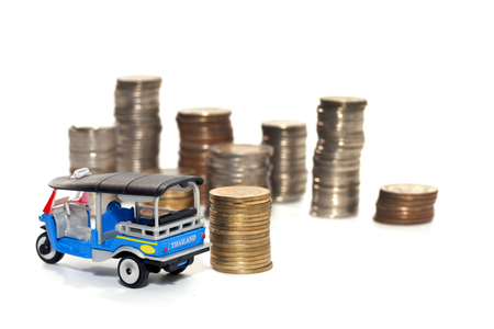 toy car and stack of coin isolated on white backgroundの写真素材