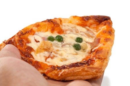 hand holding a piece of pizzaの写真素材