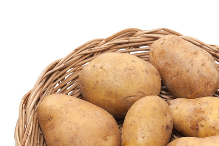 potato on basket isolated on white backgroundの写真素材