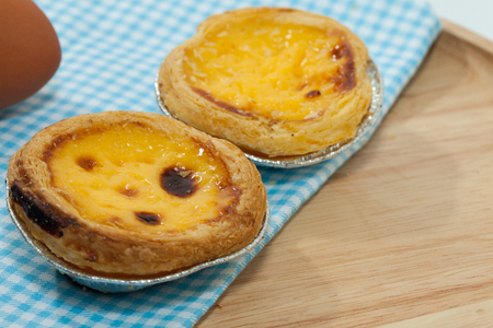 close up of egg tarts on wooden plateの写真素材