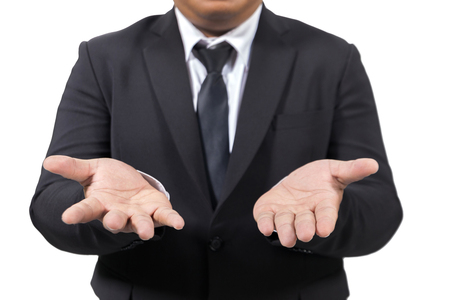 businessman in a suit opening palm handsの写真素材