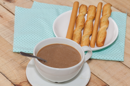 salted bread stick and cup of coffeeの写真素材