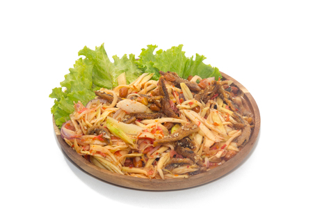 spicy green mango salad on wooden plateの写真素材