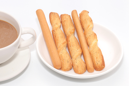 salted bread stick and cup of coffeeの写真素材