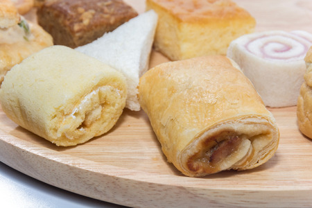 a variety of bakery on wooden plateの写真素材