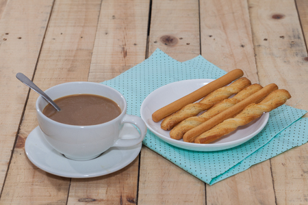 salted bread stick and cup of coffeeの写真素材