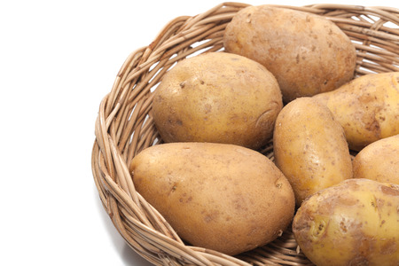 potato on basket isolated on white backgroundの写真素材
