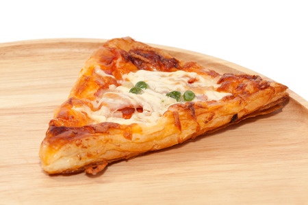 a piece of pizza on wooden plateの写真素材