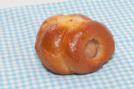 close up of chicken sausage bun on fabricの写真素材