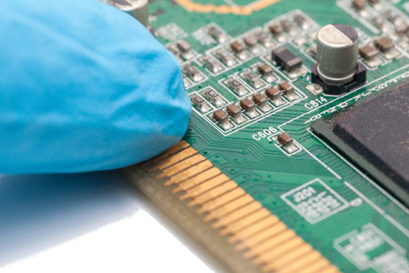 blue glove and Print Circuit Board of graphic cardの写真素材