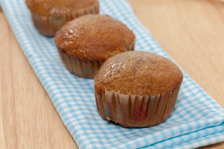 row of banana cupcake on wooden plateの写真素材