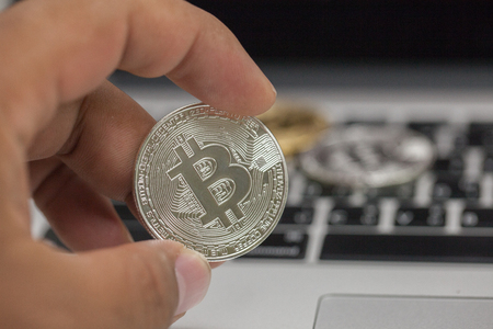 close up of hand holding metal bitcoinの写真素材