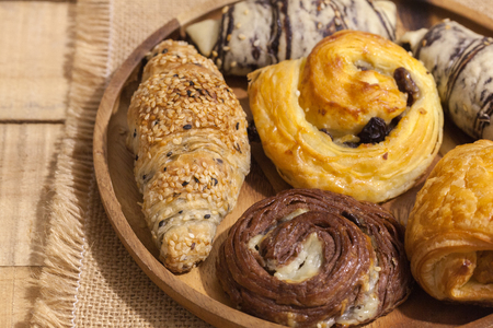 a variety of bakery on wooden plateの写真素材