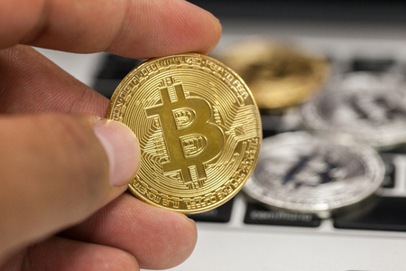 close up of hand holding metal bitcoinの写真素材