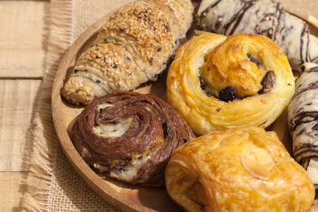 a variety of bakery on wooden plateの写真素材